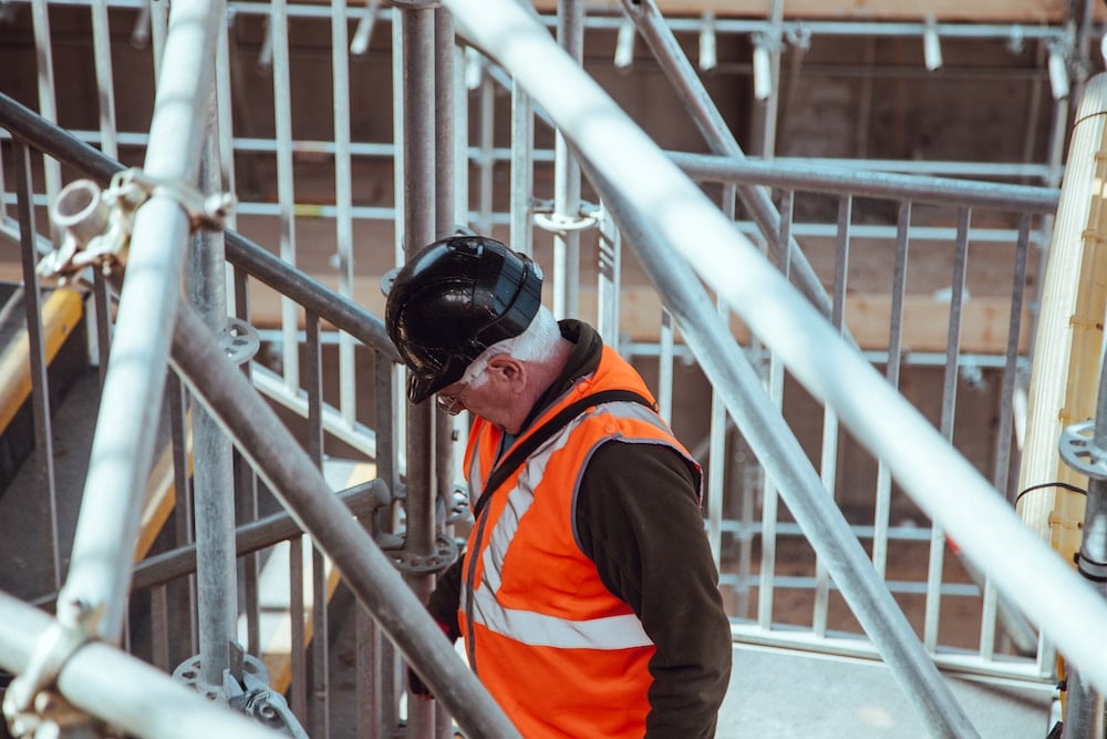 An image of a construction worker. Conduct frequent check-ins with your employees to understand their attitude toward your business.