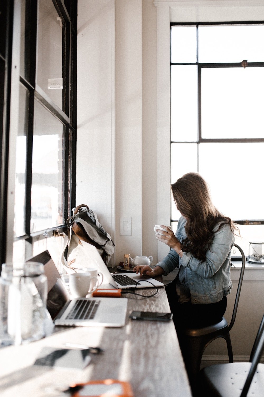 A picture of a woman working at a computer. Keeping employees feeling engaged is important to a positive employee experience.