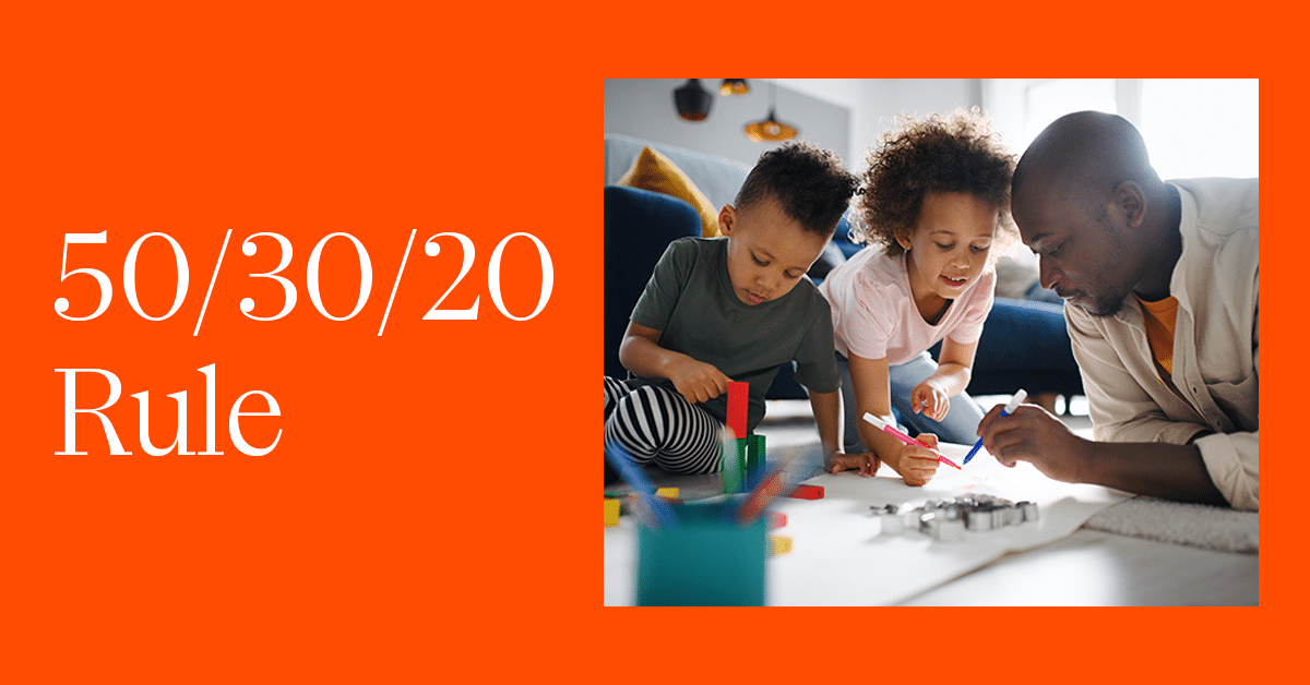 A father and his two children are drawing together on a large sheet of paper on the floor in a brightly lit living room. The text "50/30/20 Rule" is prominently displayed on the left side of the image with an orange background.